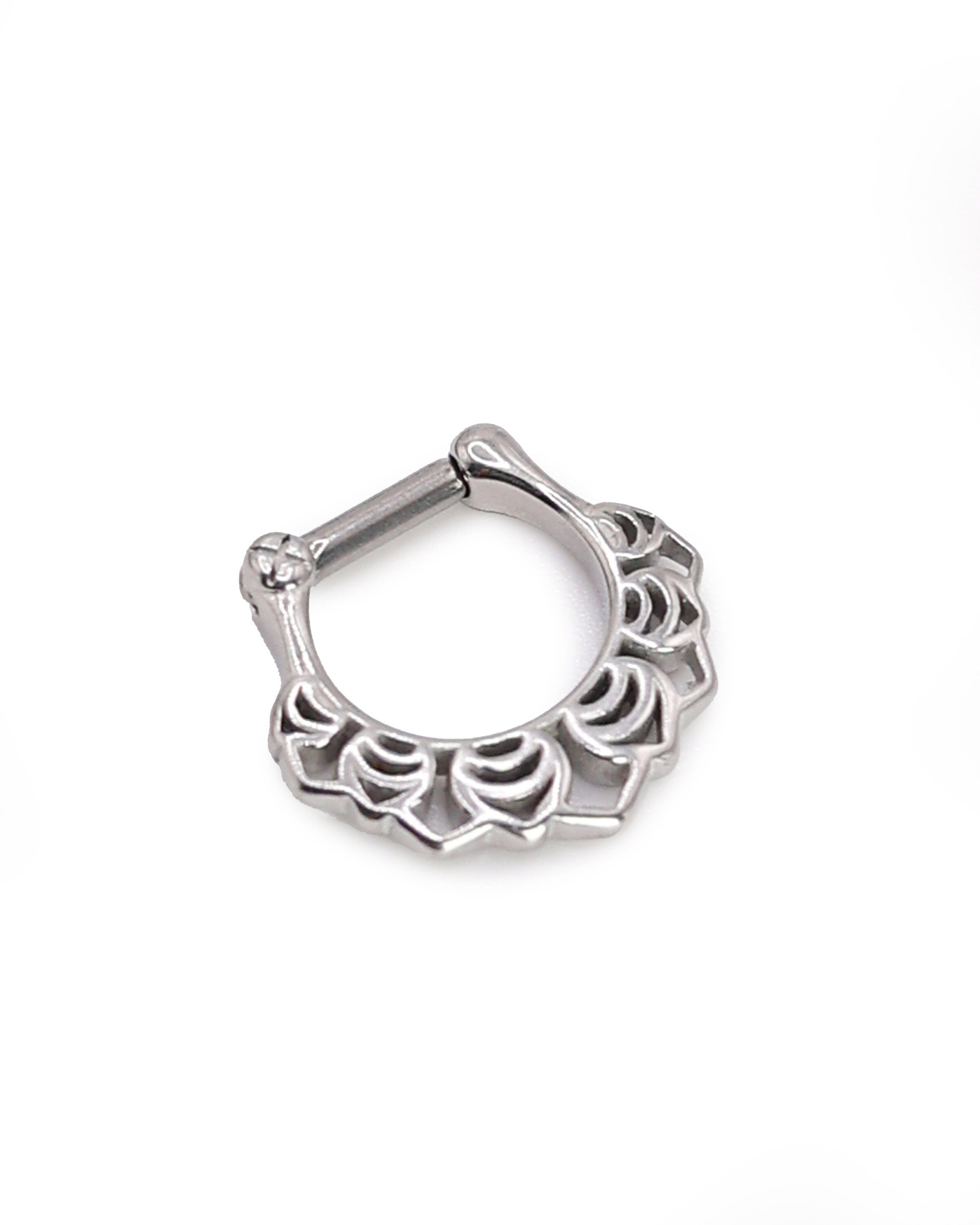 Close-up of a silver septum clicker with an Art Deco-inspired scalloped design, displayed on a white background with a secure hinged clasp.