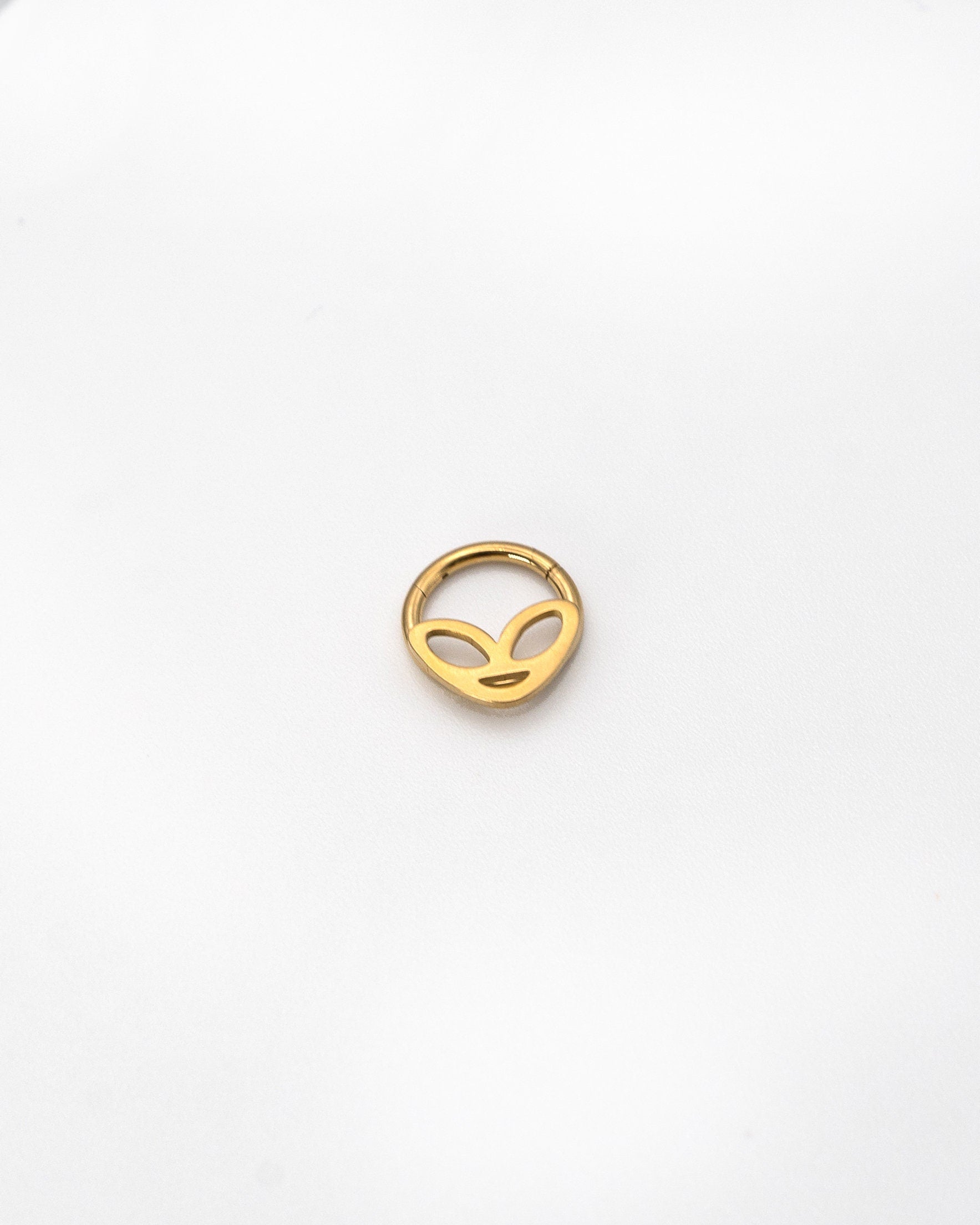 Alien-themed septum clicker in Gold finish, displayed on a white background.