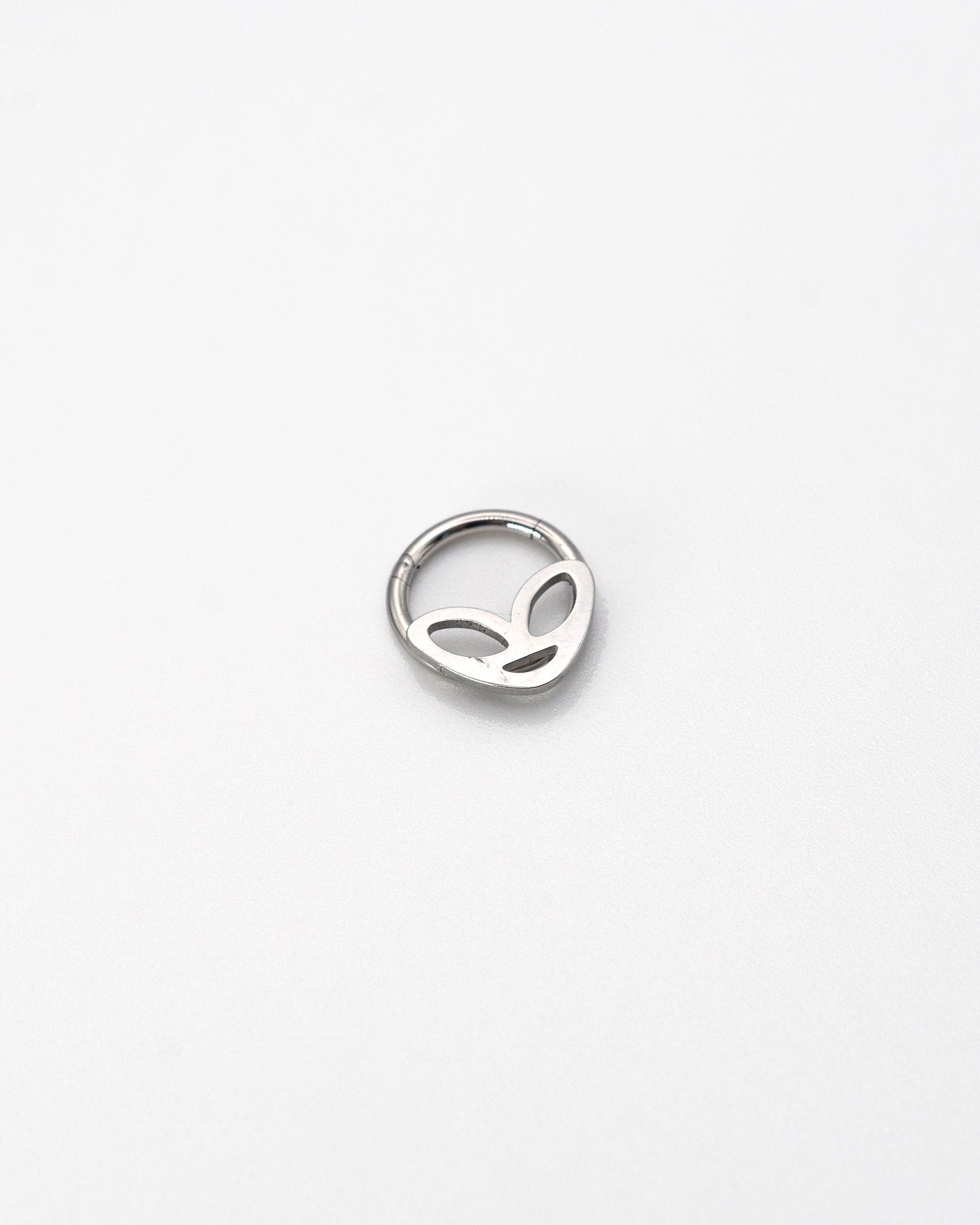 Alien-themed septum clicker in silver finish, displayed on a white background.