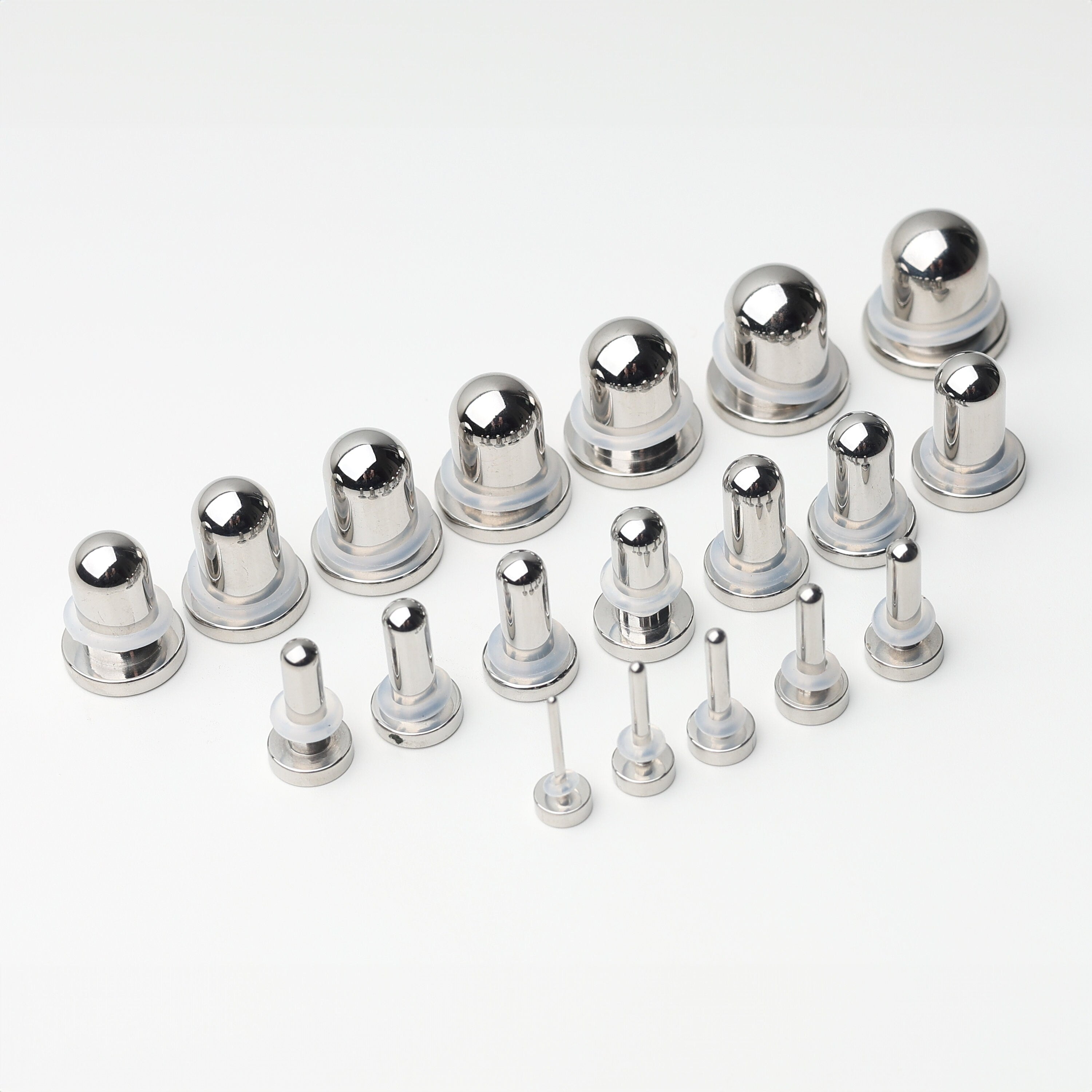 A complete dead stretching kit with polished stainless steel plugs and tunnels in multiple sizes, displayed on a white background.