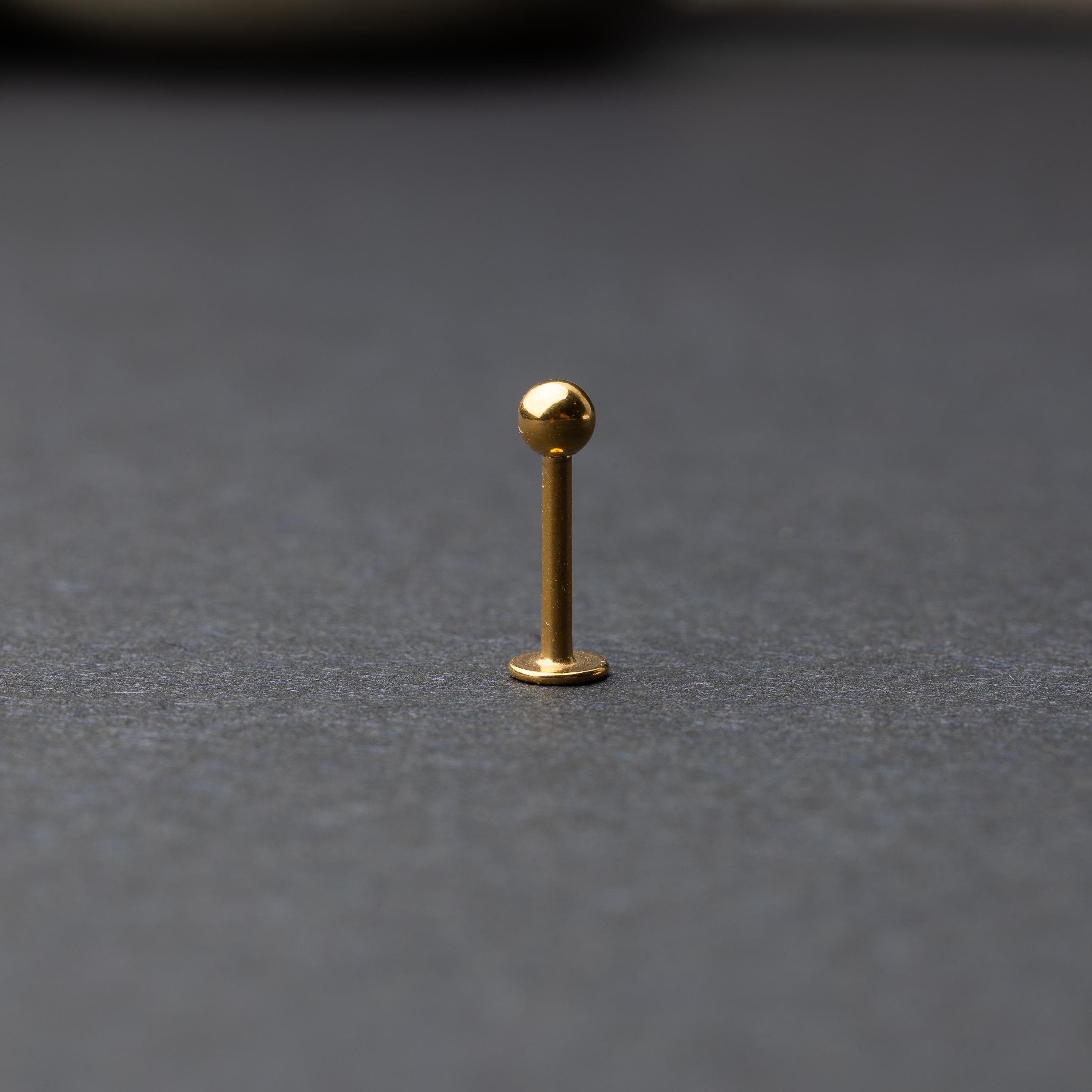 Gold Flat Back Bar displayed on a dark background.