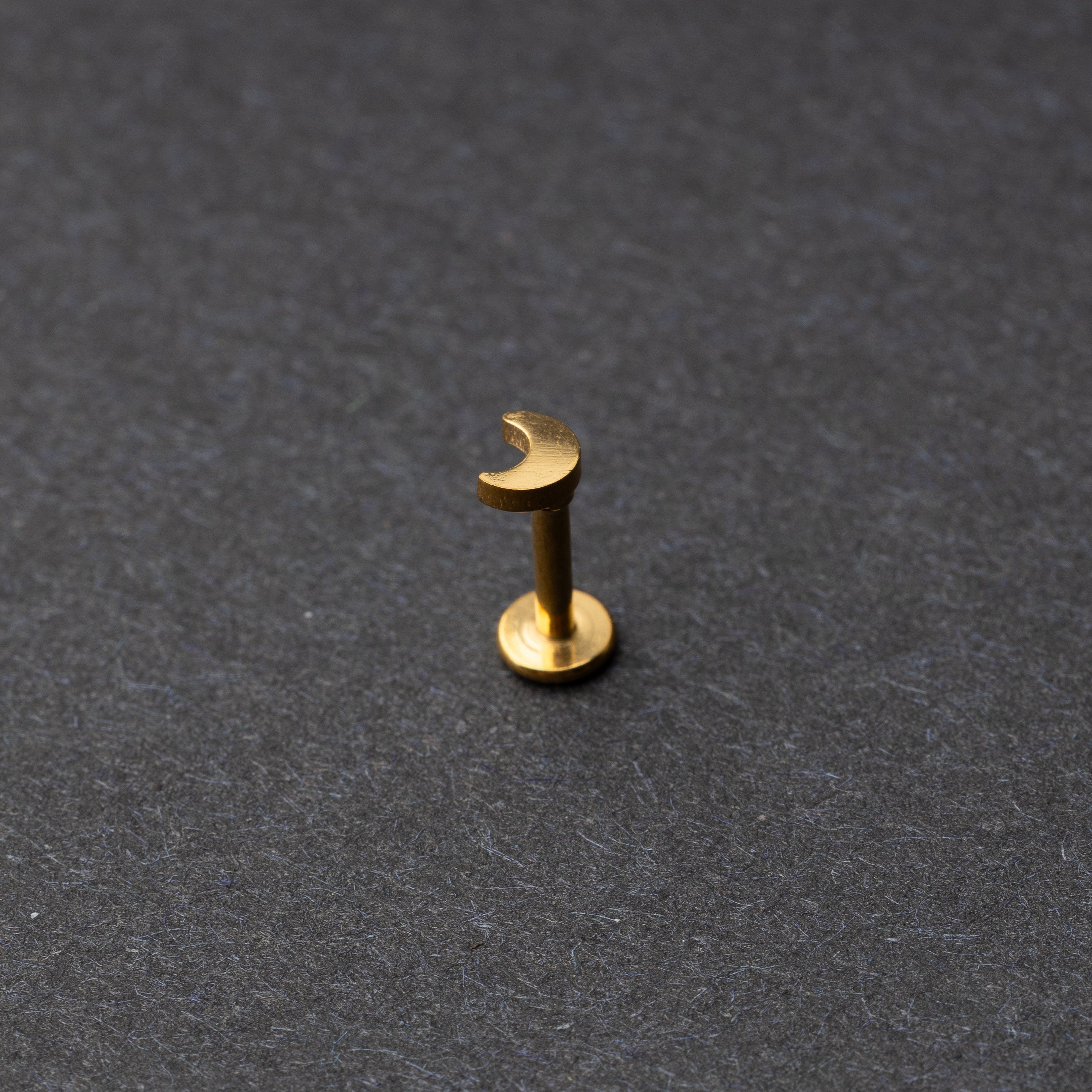 Moon flat back bar in gold displayed on a dark background