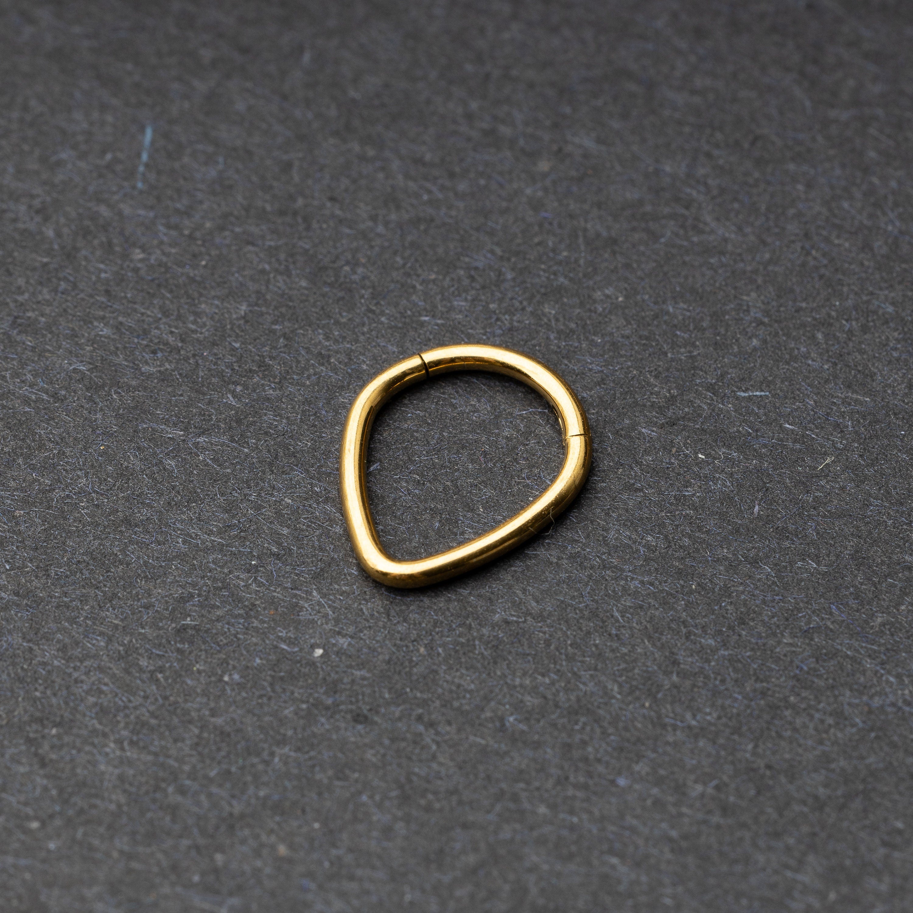 Gold Teardrop Clicker displayed on a dark background