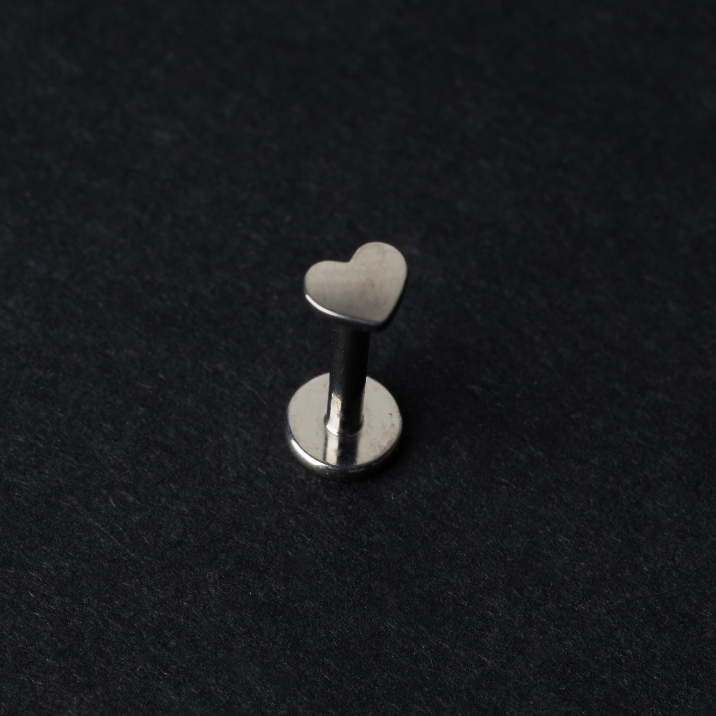 Heart-shaped Titanium labret stud on a dark background.