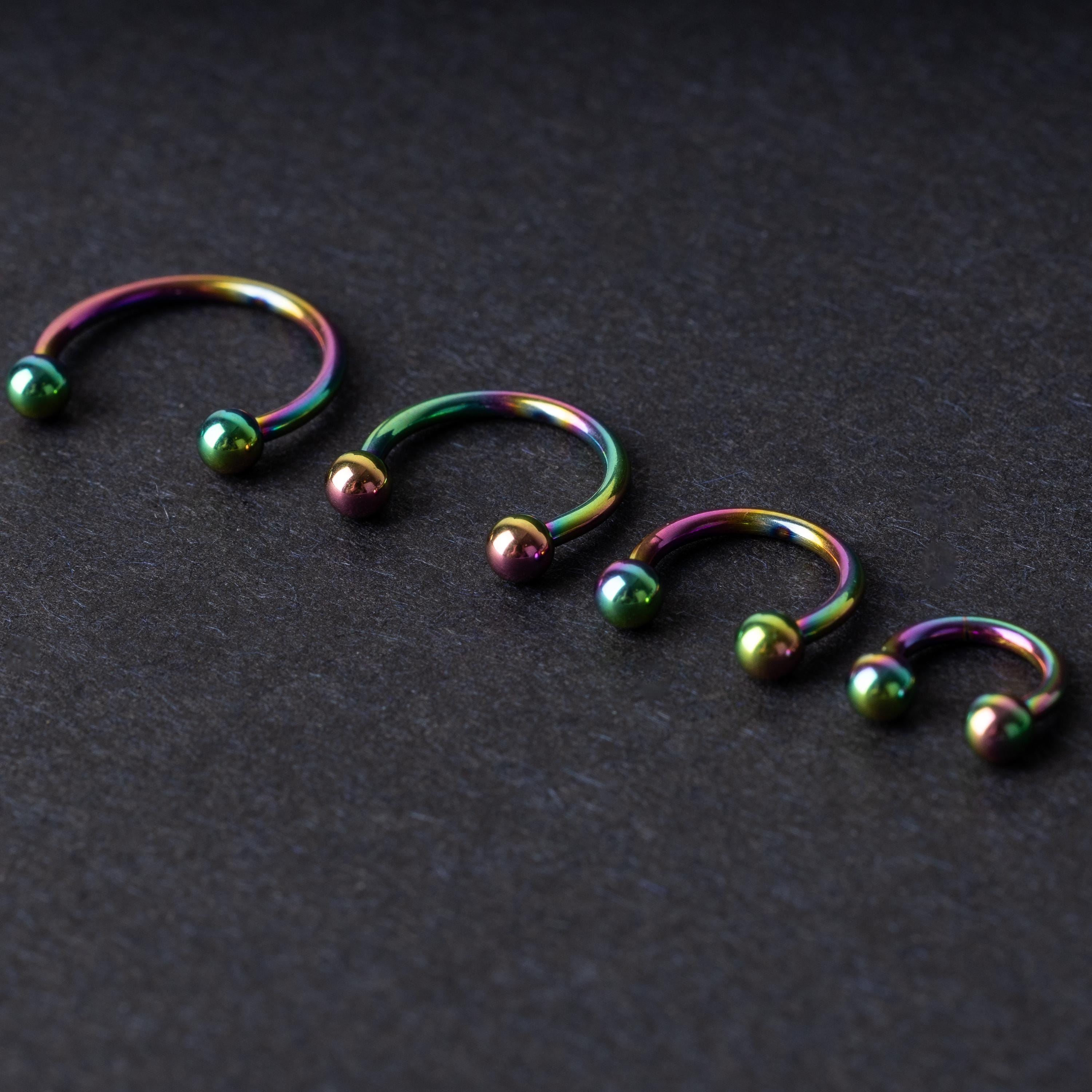 Titanium Rainbow Horseshoe Hoops in Rainbow on a dark background