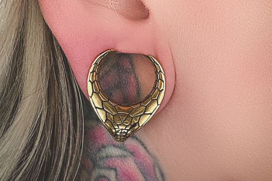woman with stretched ears, gold snake effect jewelry by morningstar body jewelry