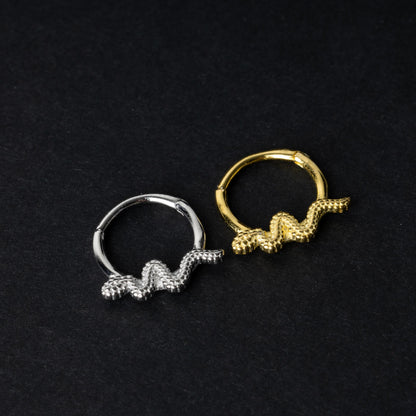 Silver and gold snake motif hinged rings crafted from 925 Sterling Silver on a dark background.
