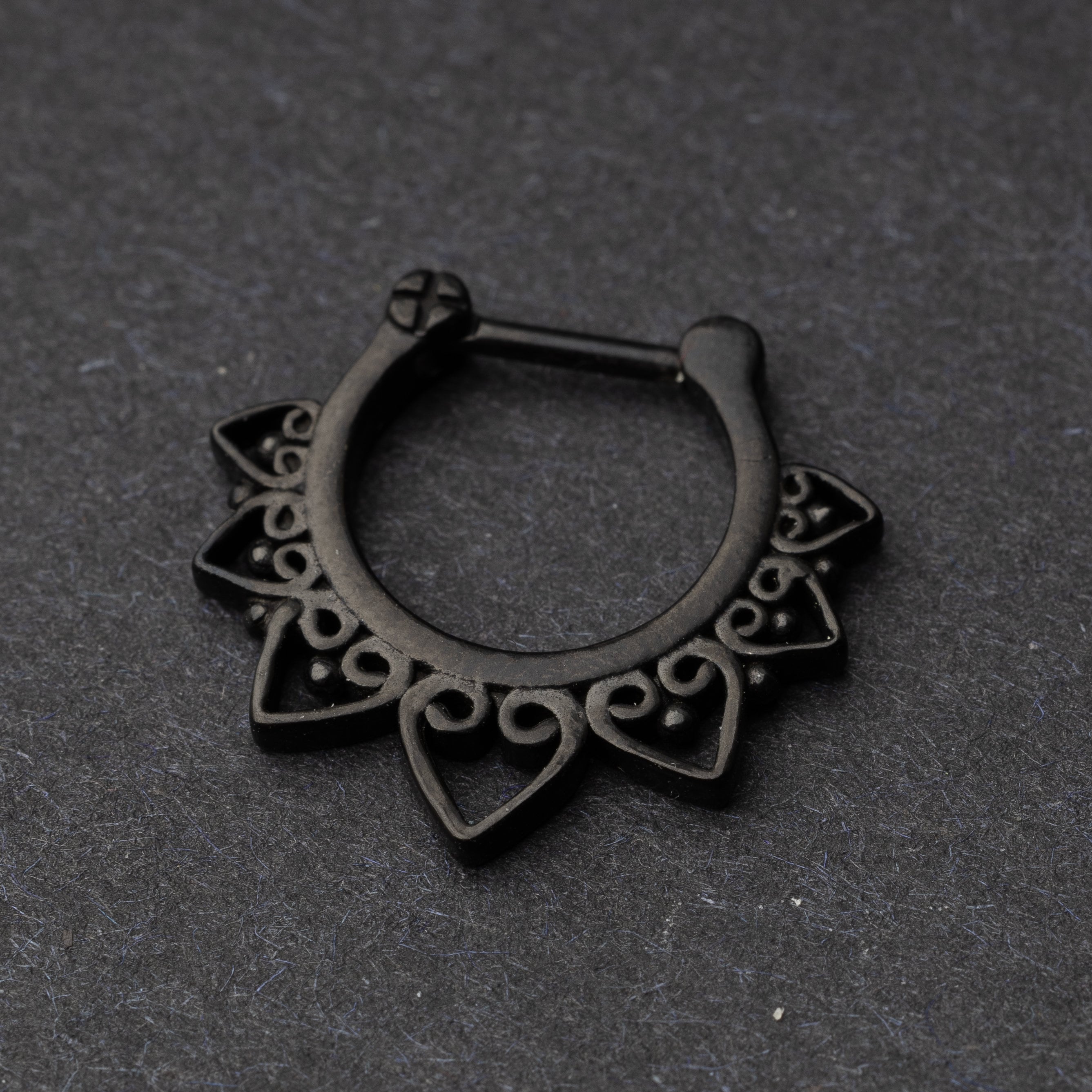Black Ornate Septum Clicker on a dark background