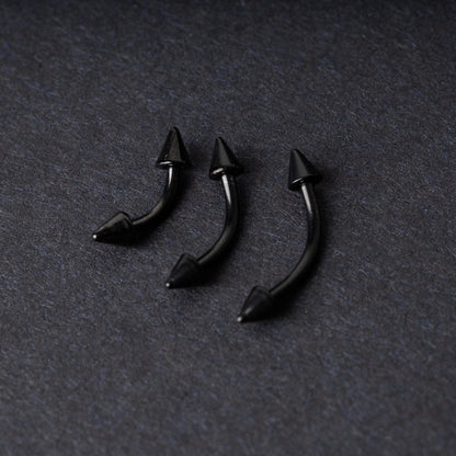 Three black curved barbells with spiked ends, displayed on a dark background with a polished finish.