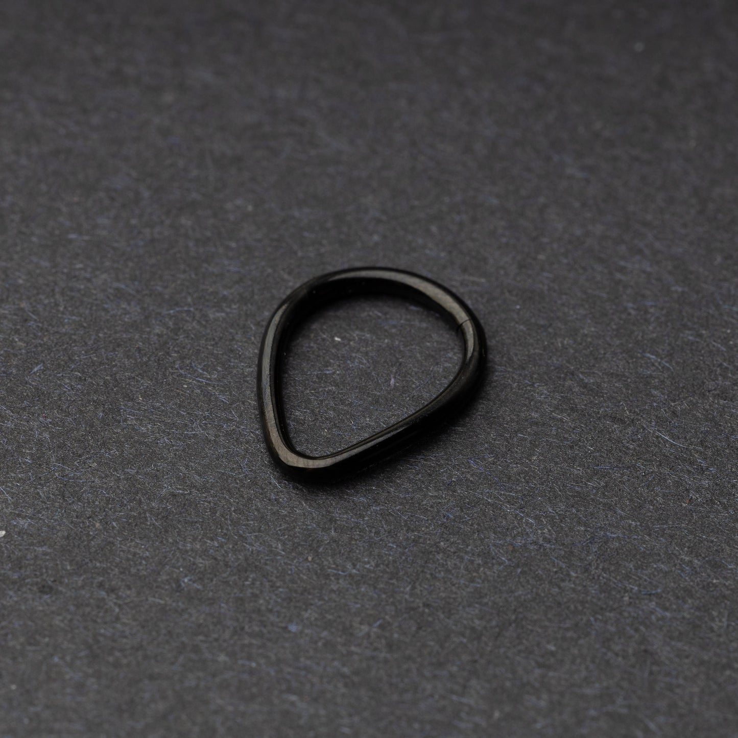 Black Teardrop Clicker displayed on a dark background