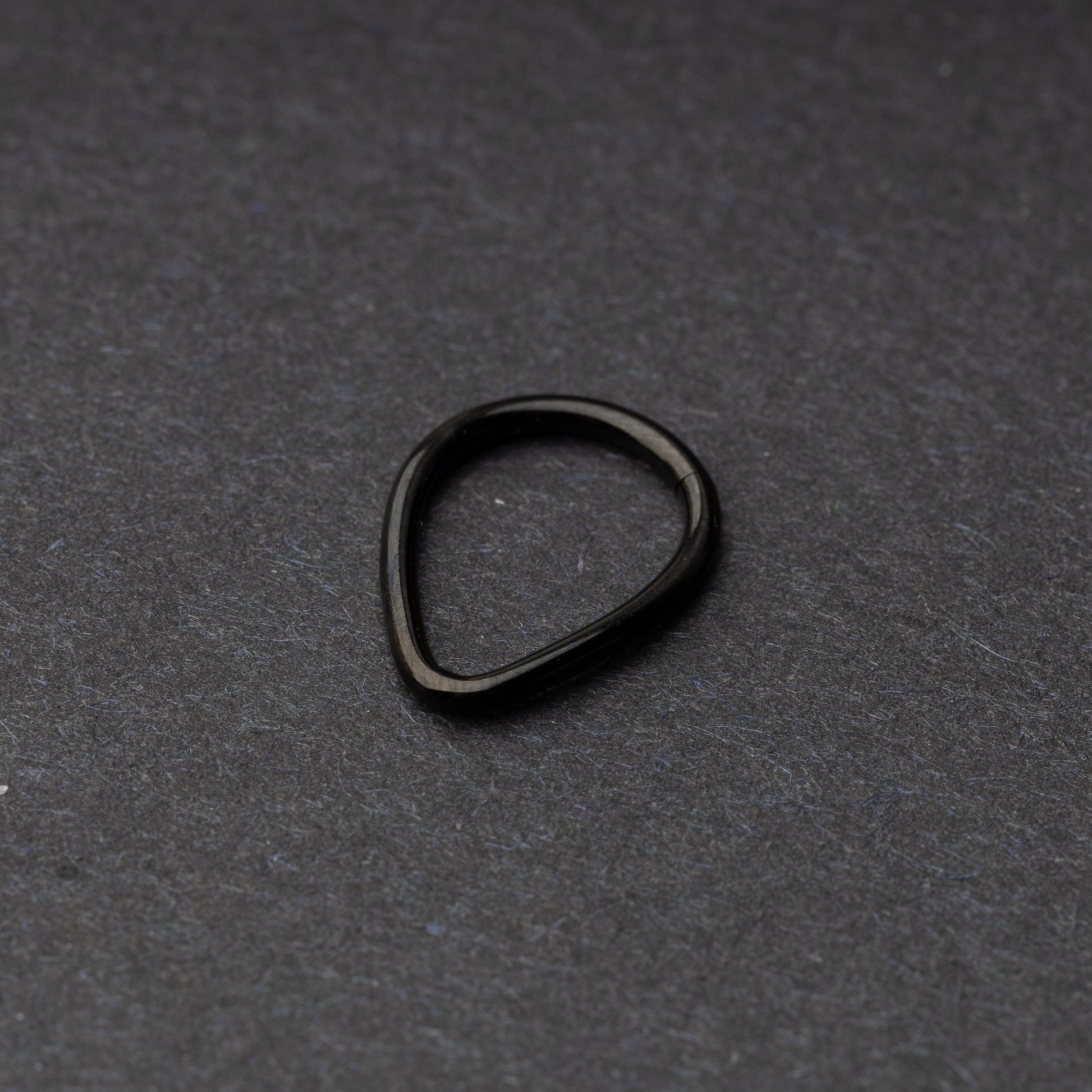 Black Teardrop Clicker displayed on a dark background