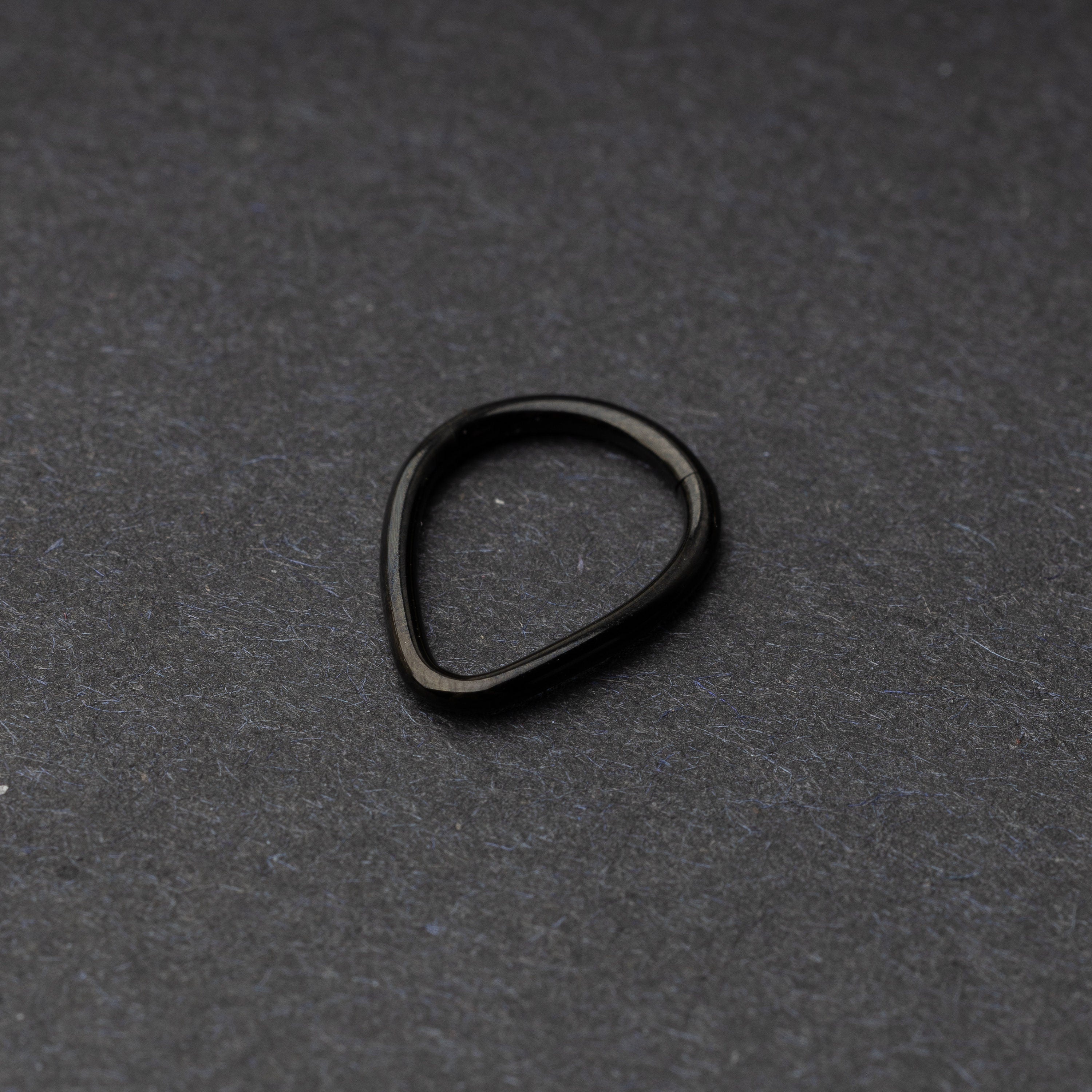 Black Teardrop Clicker displayed on a dark background