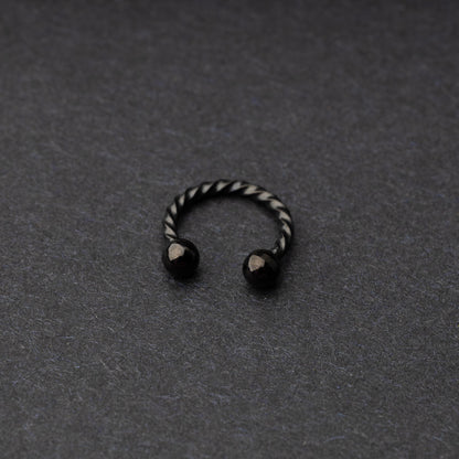 Twisted horseshoe barbells in black finish displayed on a dark background, highlighting their bold and unique design.