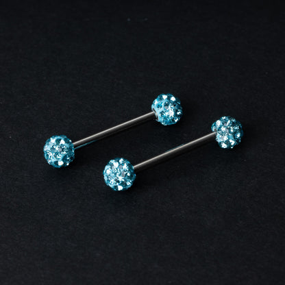 Barbells with textured crystal-encrusted ends in icy blue displayed on a dark background.