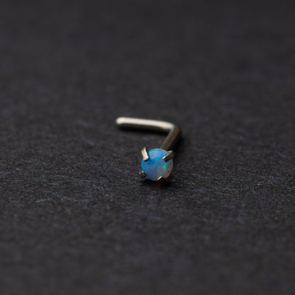 Opal L shaped nose stud on a dark background