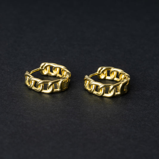 Gold hoop earrings with a chain-link design, displayed on a dark background.
