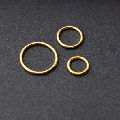 Seamless Clicker hoop in gold, showcasing four different sizes displayed on a dark background