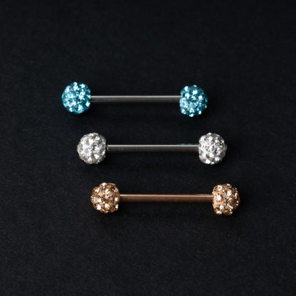 Barbells with textured crystal-encrusted ends in silver, gold, and icy blue finishes, displayed on a dark background.