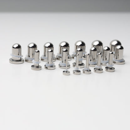 A complete dead stretching kit with polished stainless steel plugs and tunnels in multiple sizes, displayed on a white background