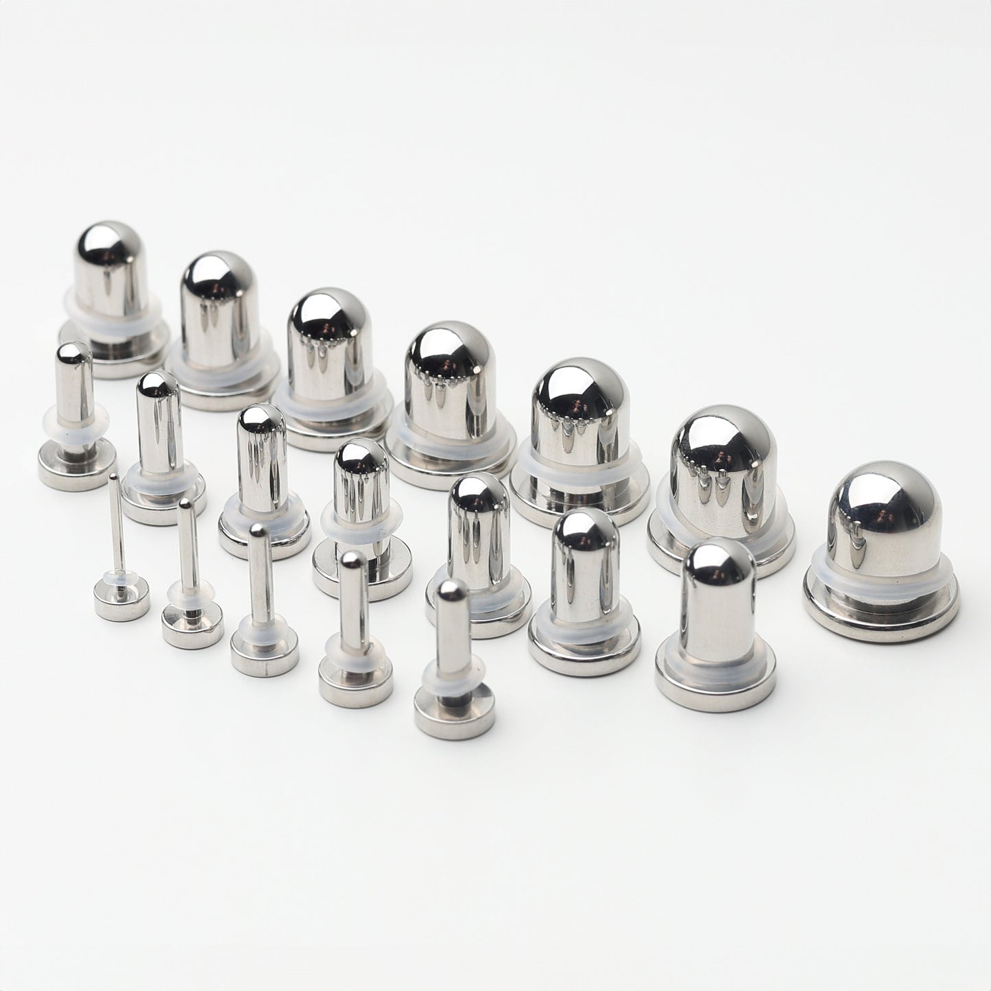 A complete dead stretching kit with polished stainless steel plugs and tunnels in multiple sizes, displayed on a white background.