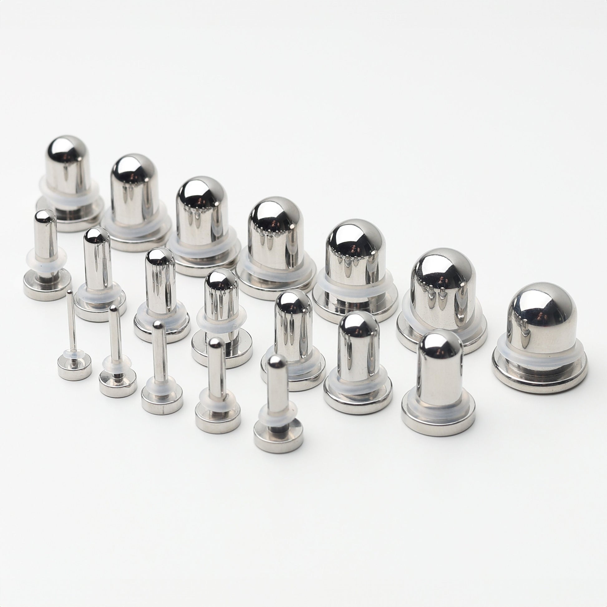 A complete dead stretching kit with polished stainless steel plugs and tunnels in multiple sizes, displayed on a white background.