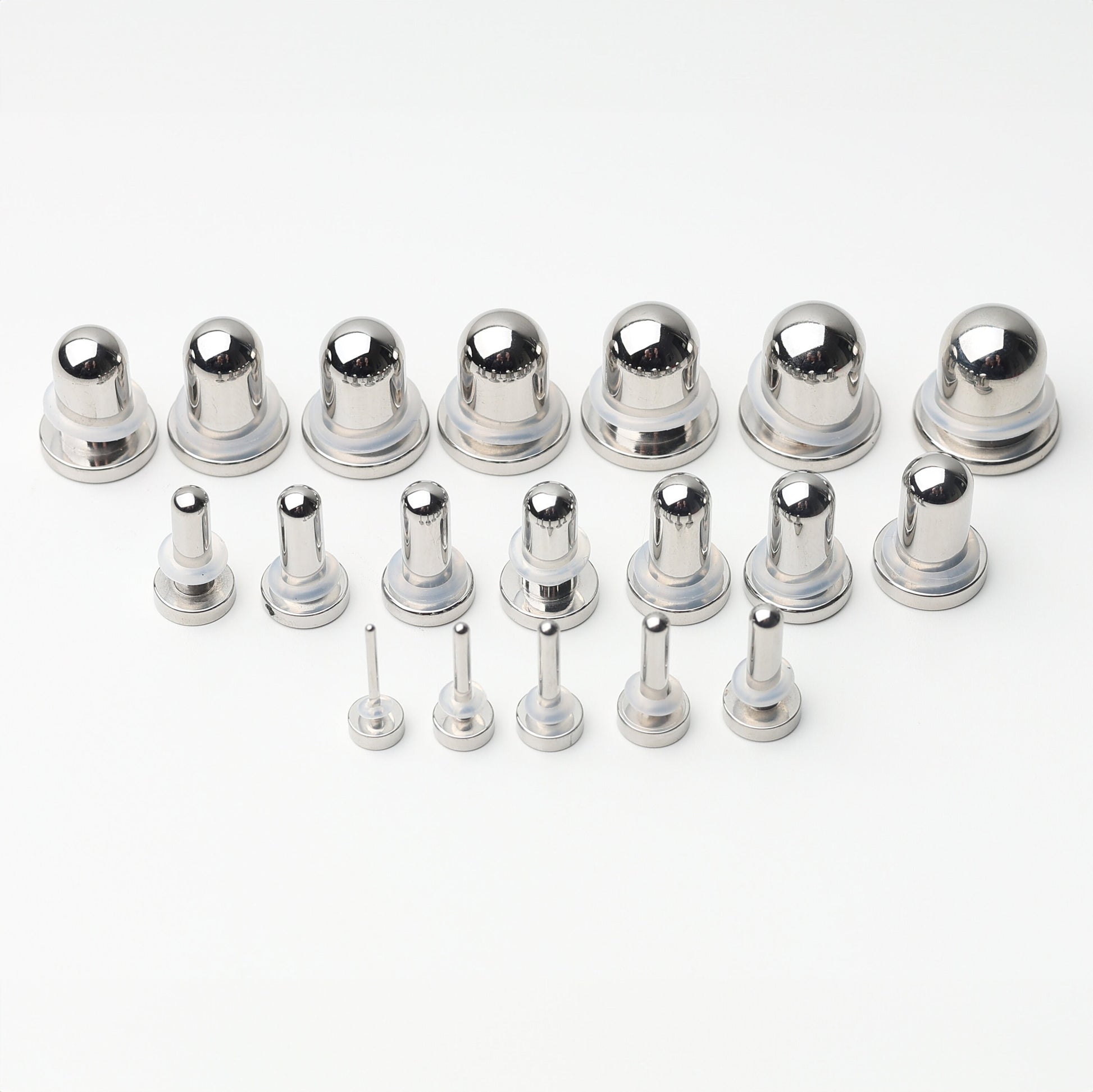 A complete dead stretching kit with polished stainless steel plugs and tunnels in multiple sizes, displayed on a white background.