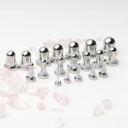 A complete dead stretching kit with polished stainless steel plugs and tunnels in multiple sizes, displayed on a white background