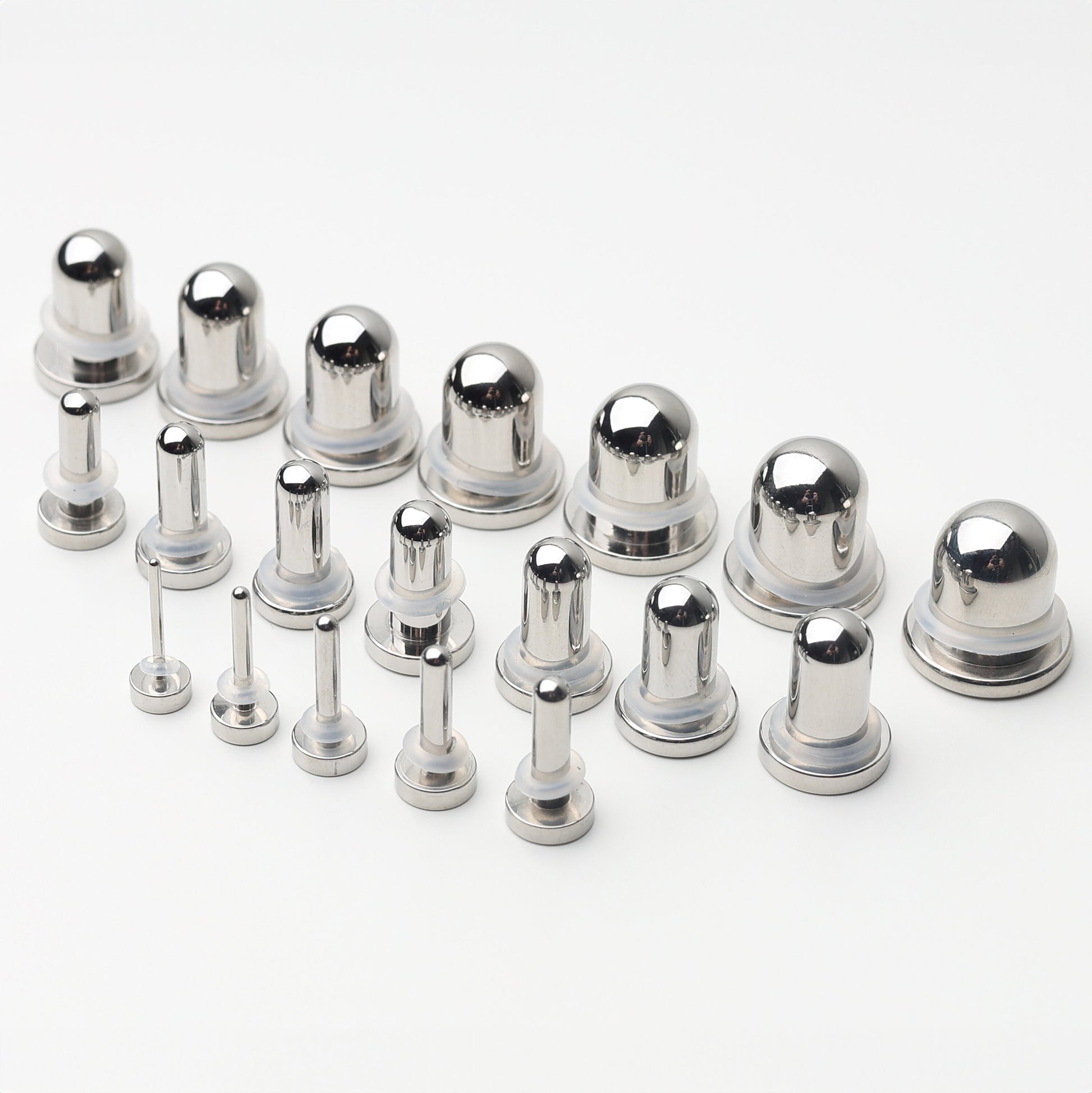 A complete dead stretching kit with polished stainless steel plugs and tunnels in multiple sizes, displayed on a white background.