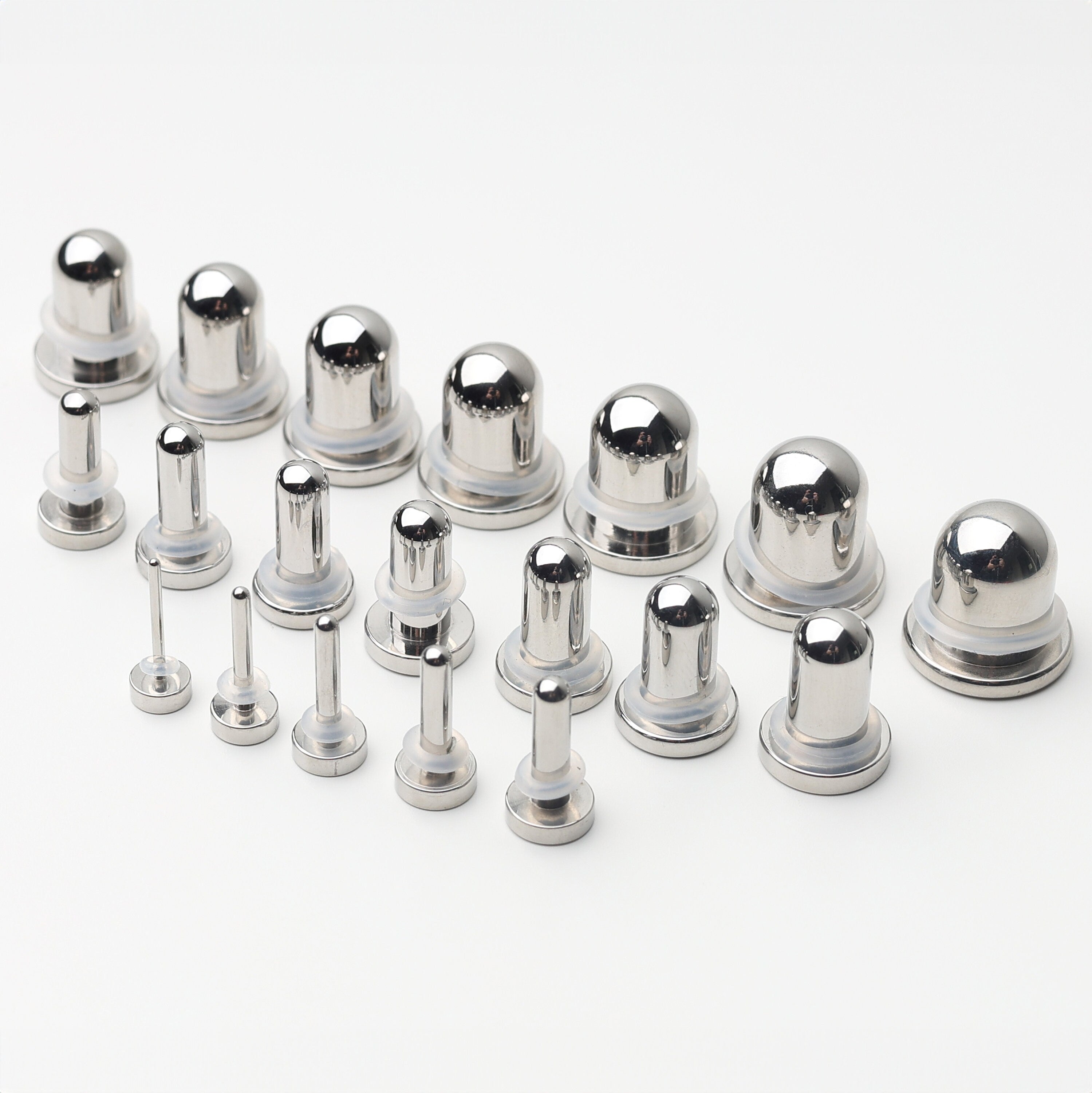 A complete dead stretching kit with polished stainless steel plugs and tunnels in multiple sizes, displayed on a white background.