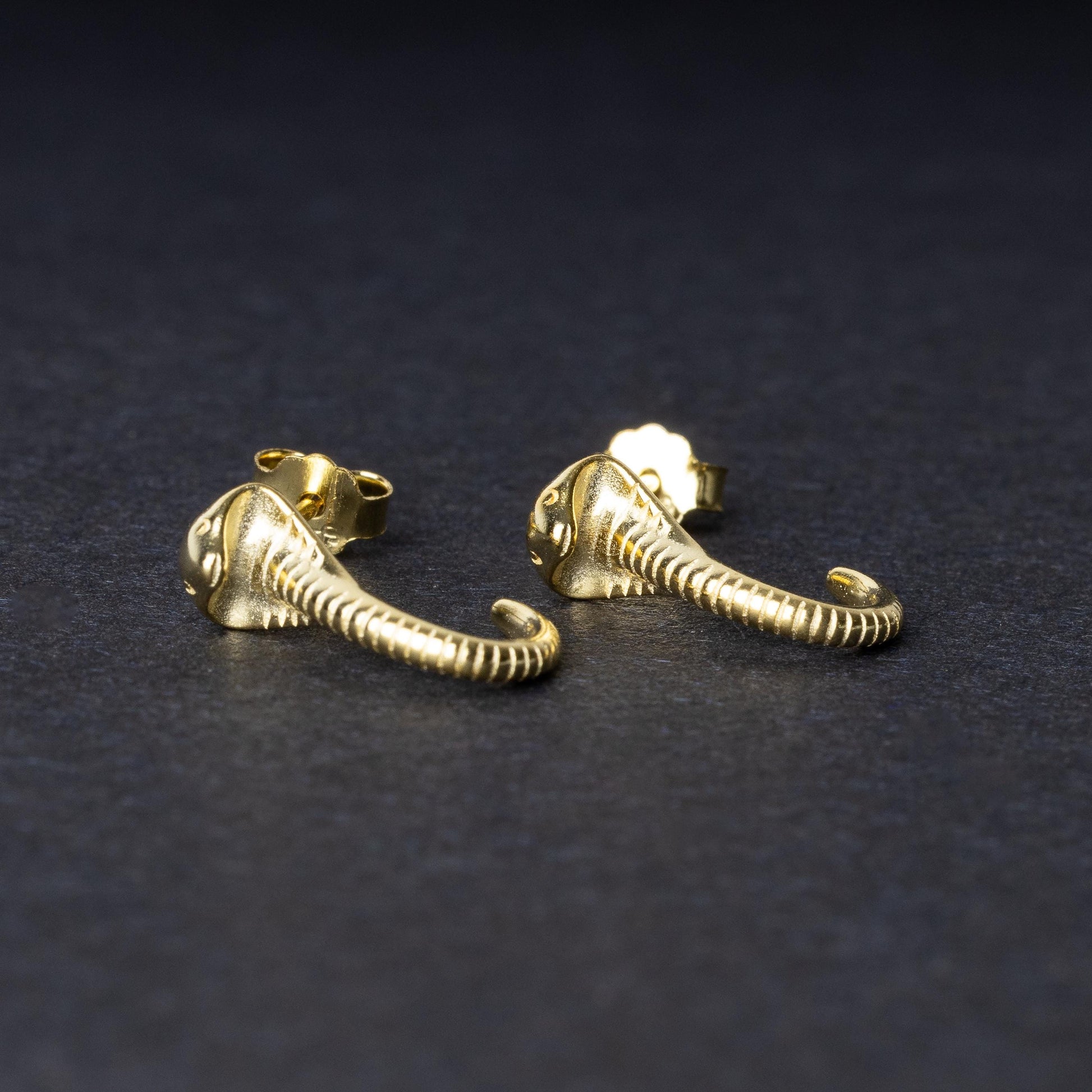 Gold-toned cobra-shaped stud earrings with intricate detailing, crafted from 925 sterling silver, displayed on a black background.