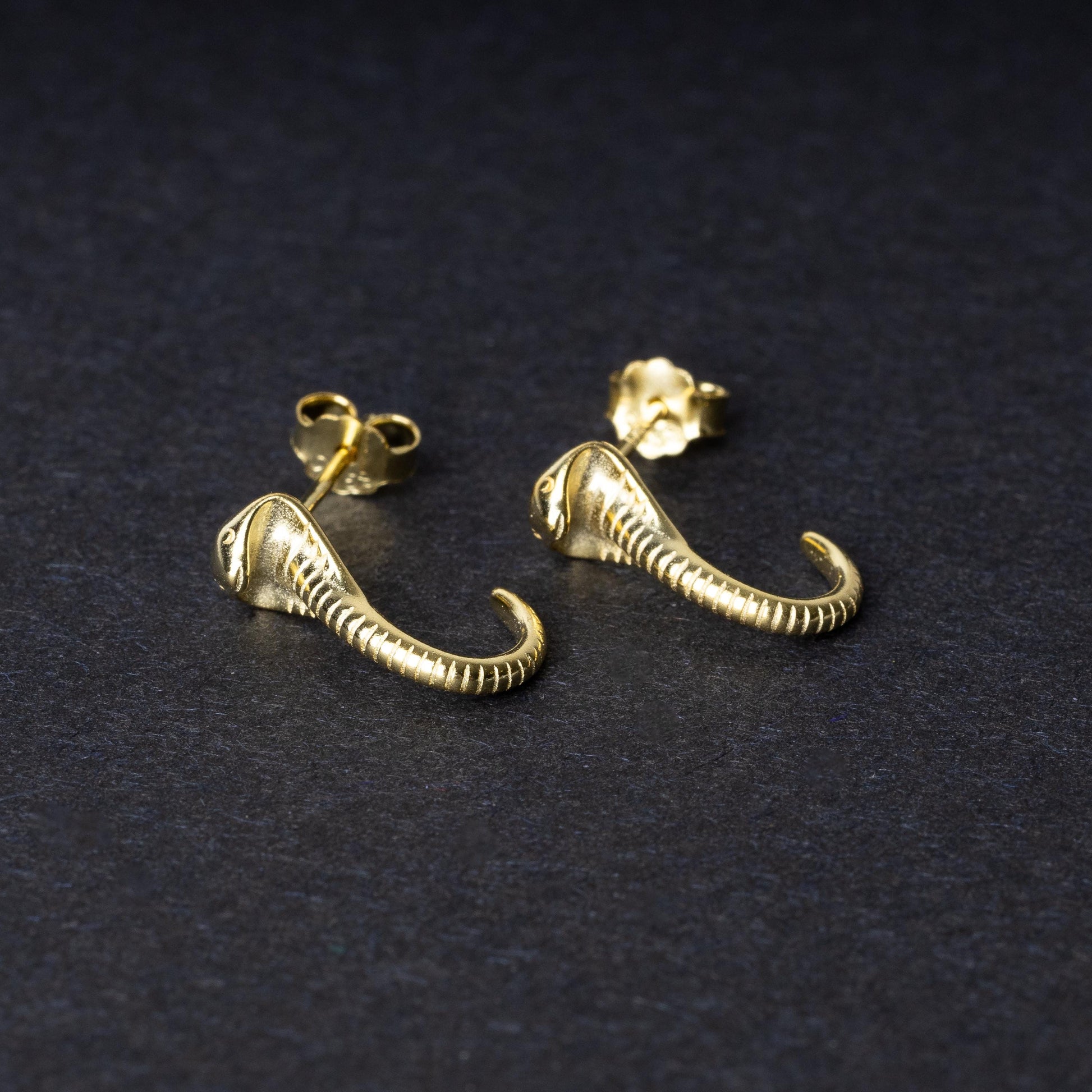 Gold-toned cobra-shaped stud earrings with intricate detailing, crafted from 925 sterling silver, displayed on a black background.