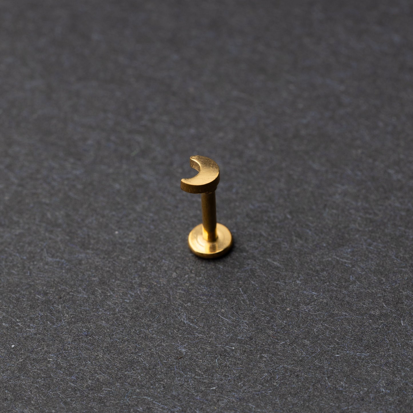Moon flat back bar in gold displayed on a dark background