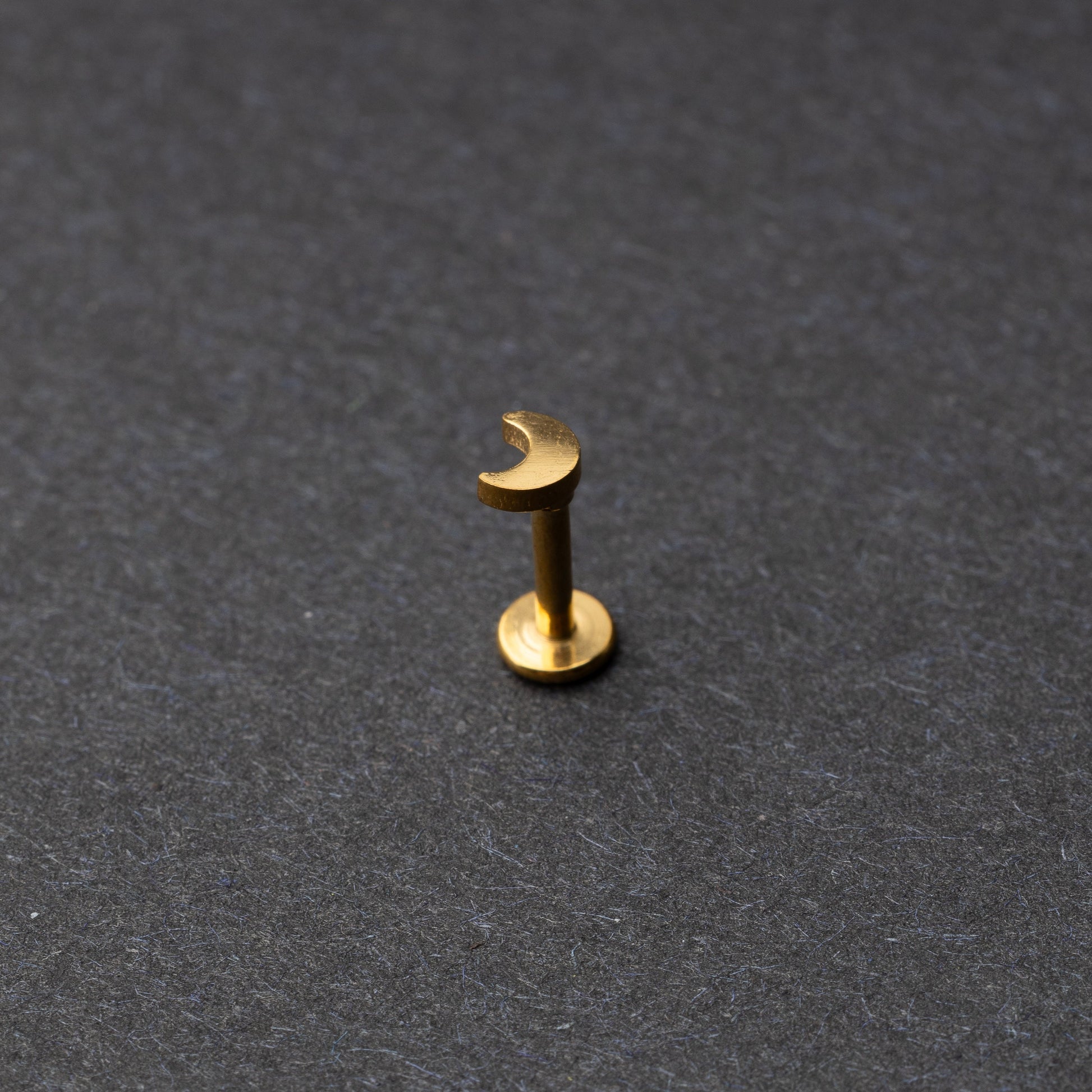 Moon flat back bar in gold displayed on a dark background