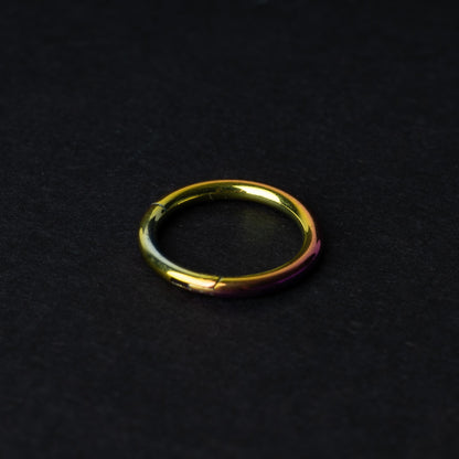 A gold Seamless Clicker displayed on a dark background.