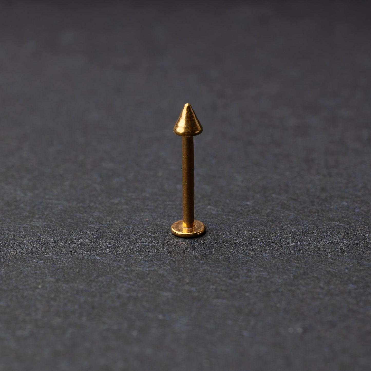 A single spiked flat back bar on a dark background. 