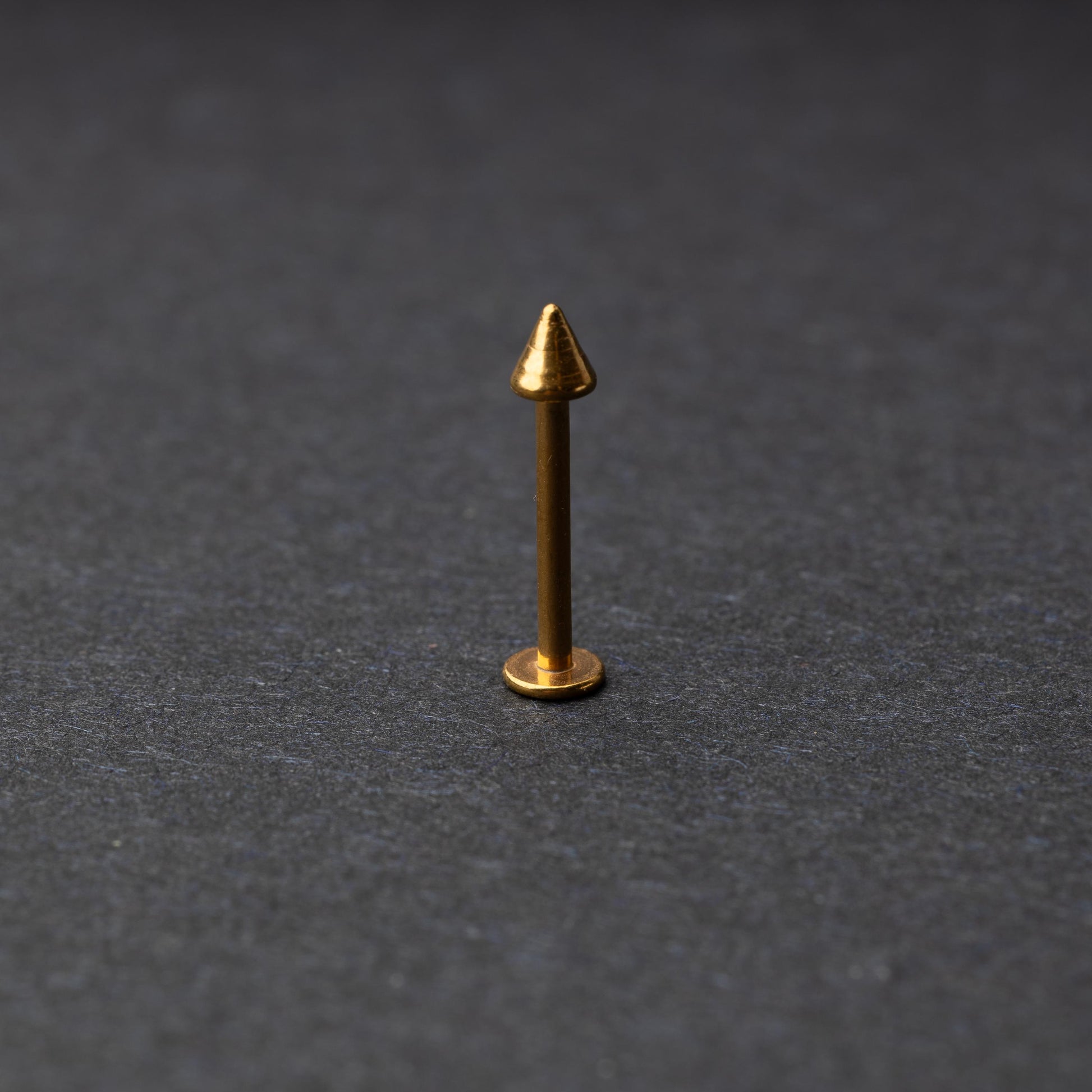 A single spiked flat back bar on a dark background. 