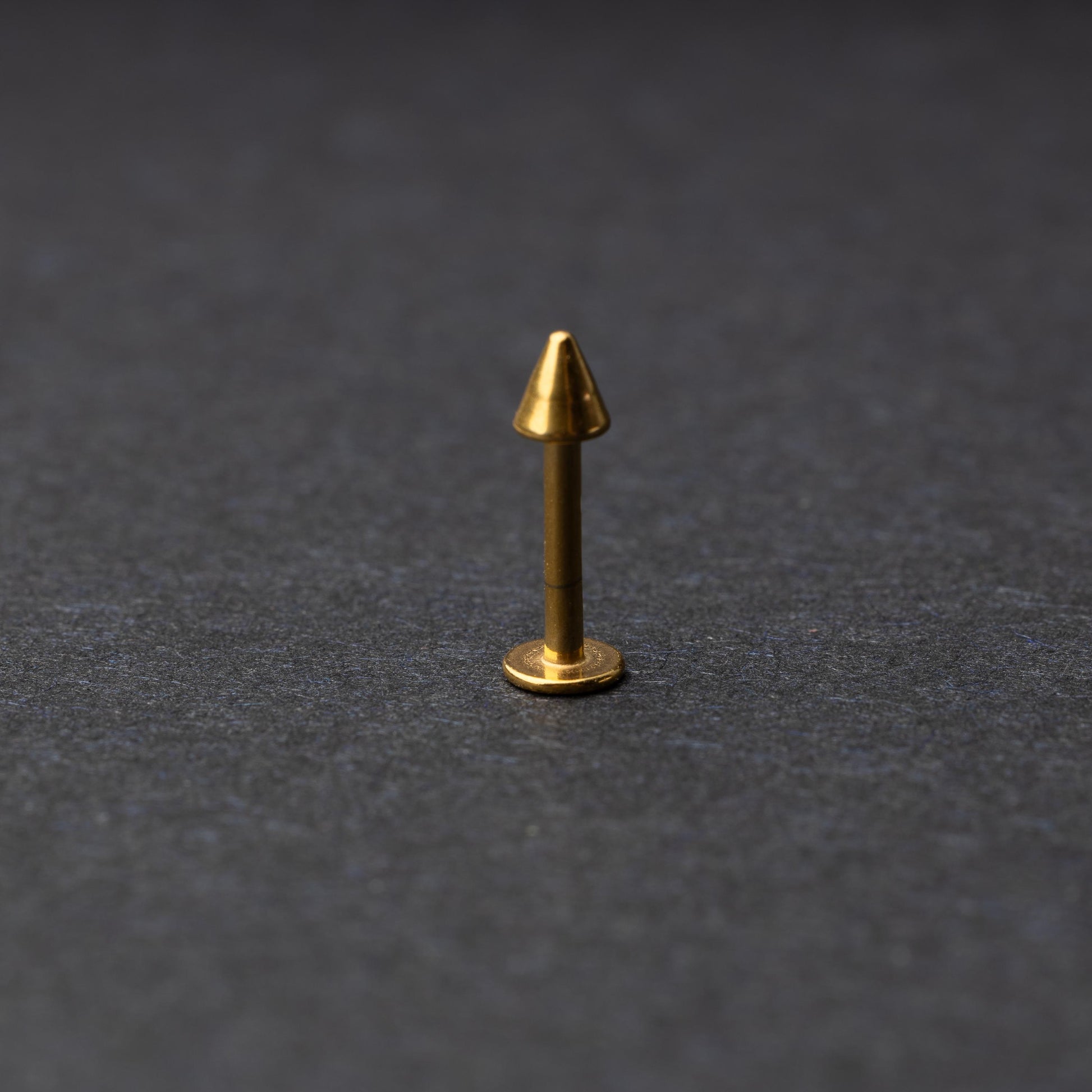 A single spiked flat back bar on a dark background. 