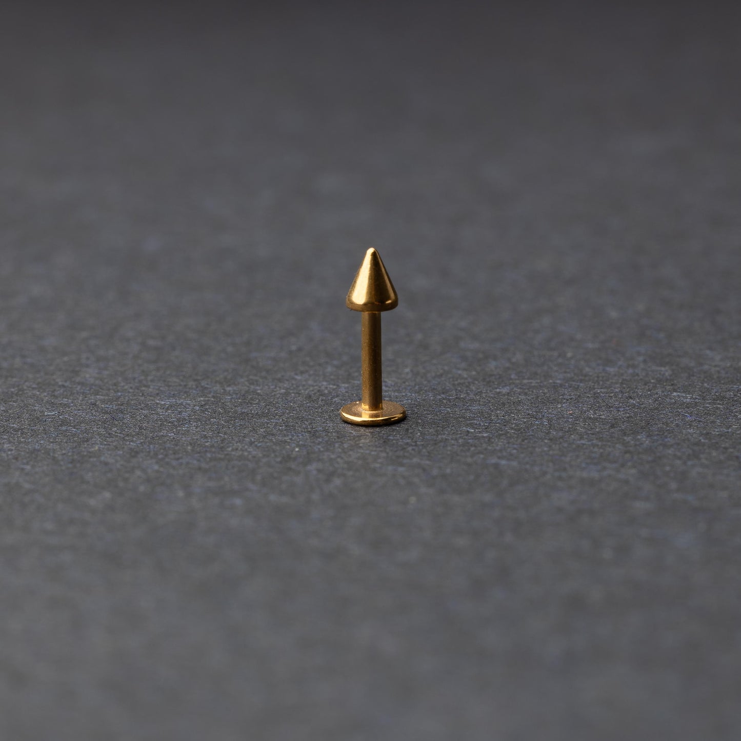 A single spiked flat back bar on a dark background. 