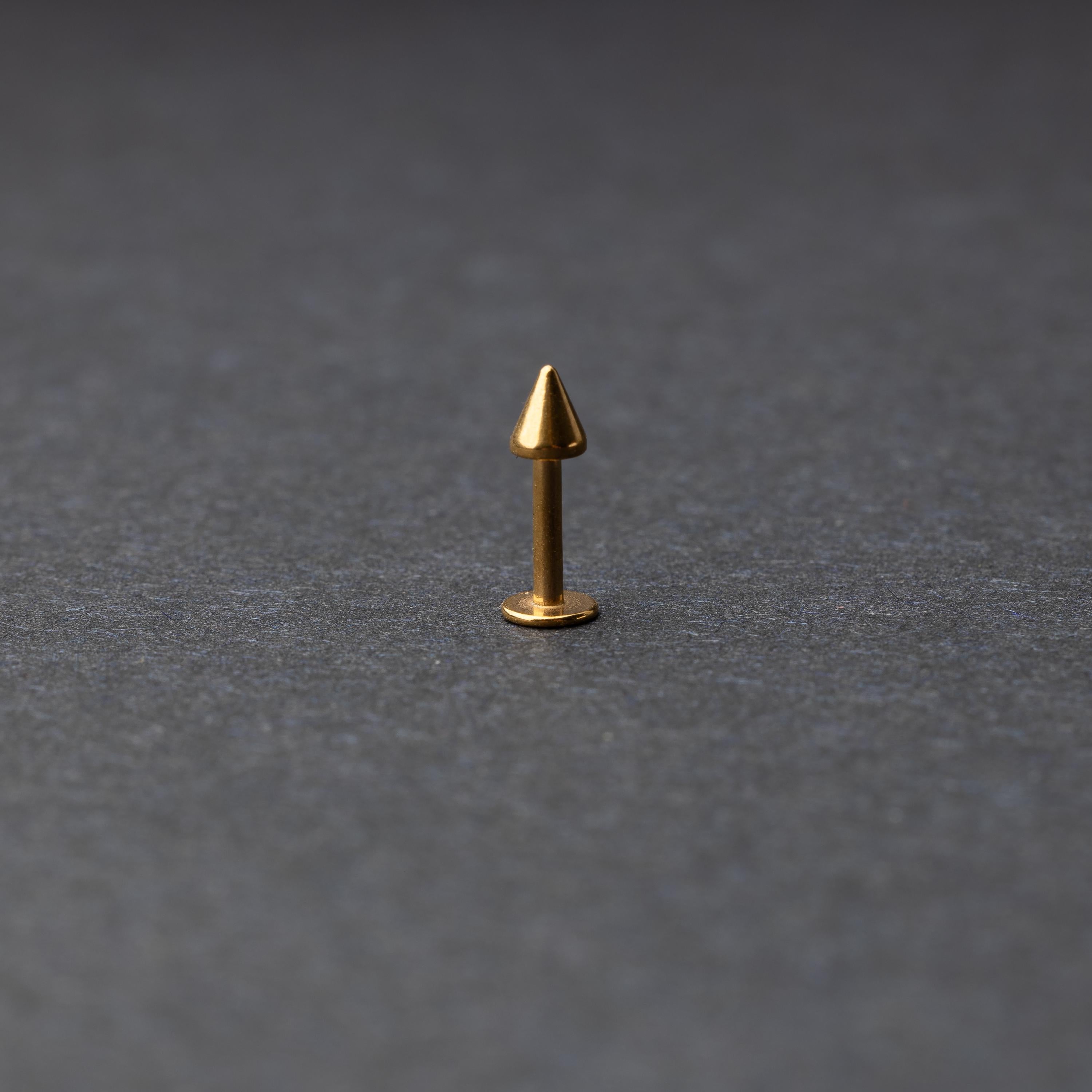 A single spiked flat back bar on a dark background. 