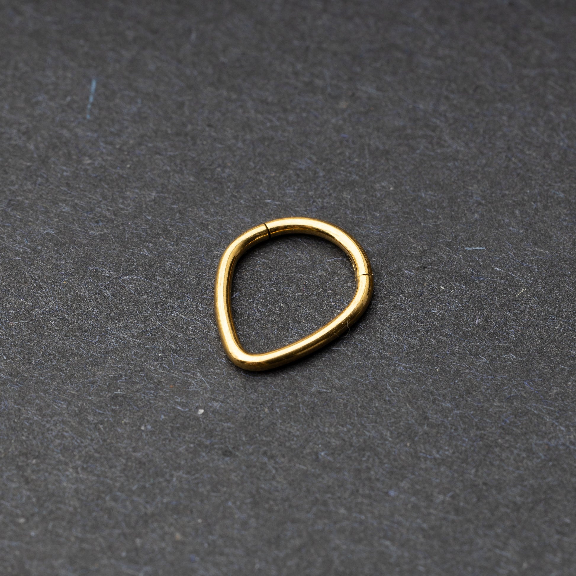 Gold Teardrop Clicker displayed on a dark background