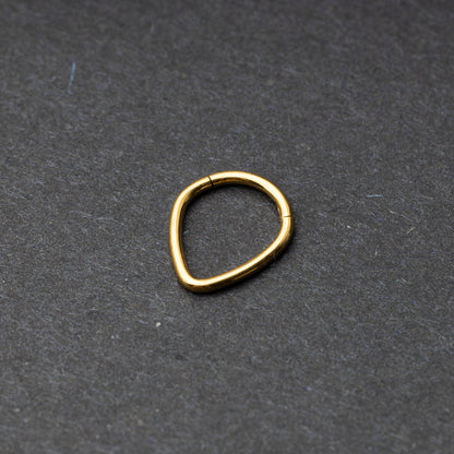 Gold Teardrop Clicker displayed on a dark background