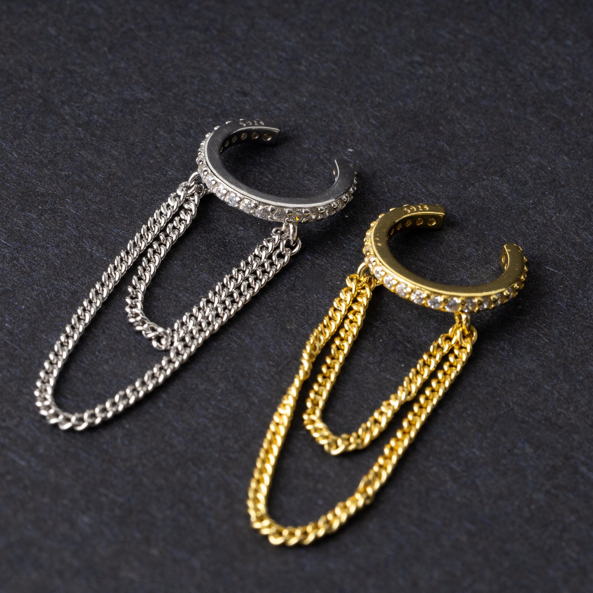 Septum clicker with double chains and gem-encrusted arc, in silver shown on a display ear. 