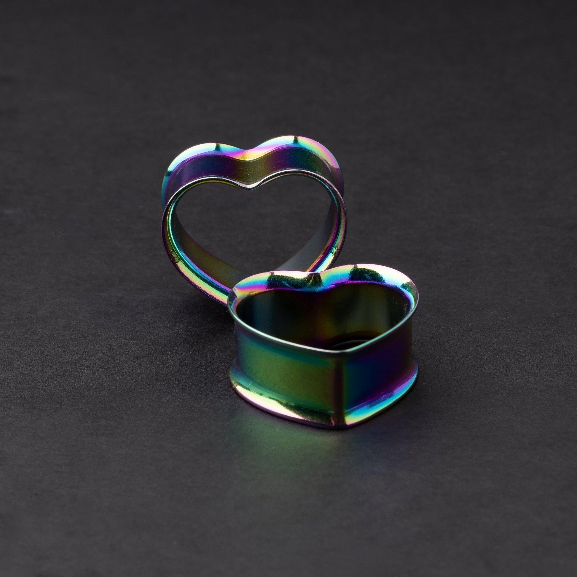 Heart-shaped tunnels in rainbow, displayed on a dark background.