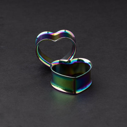 Heart-shaped tunnels in rainbow, displayed on a dark background.