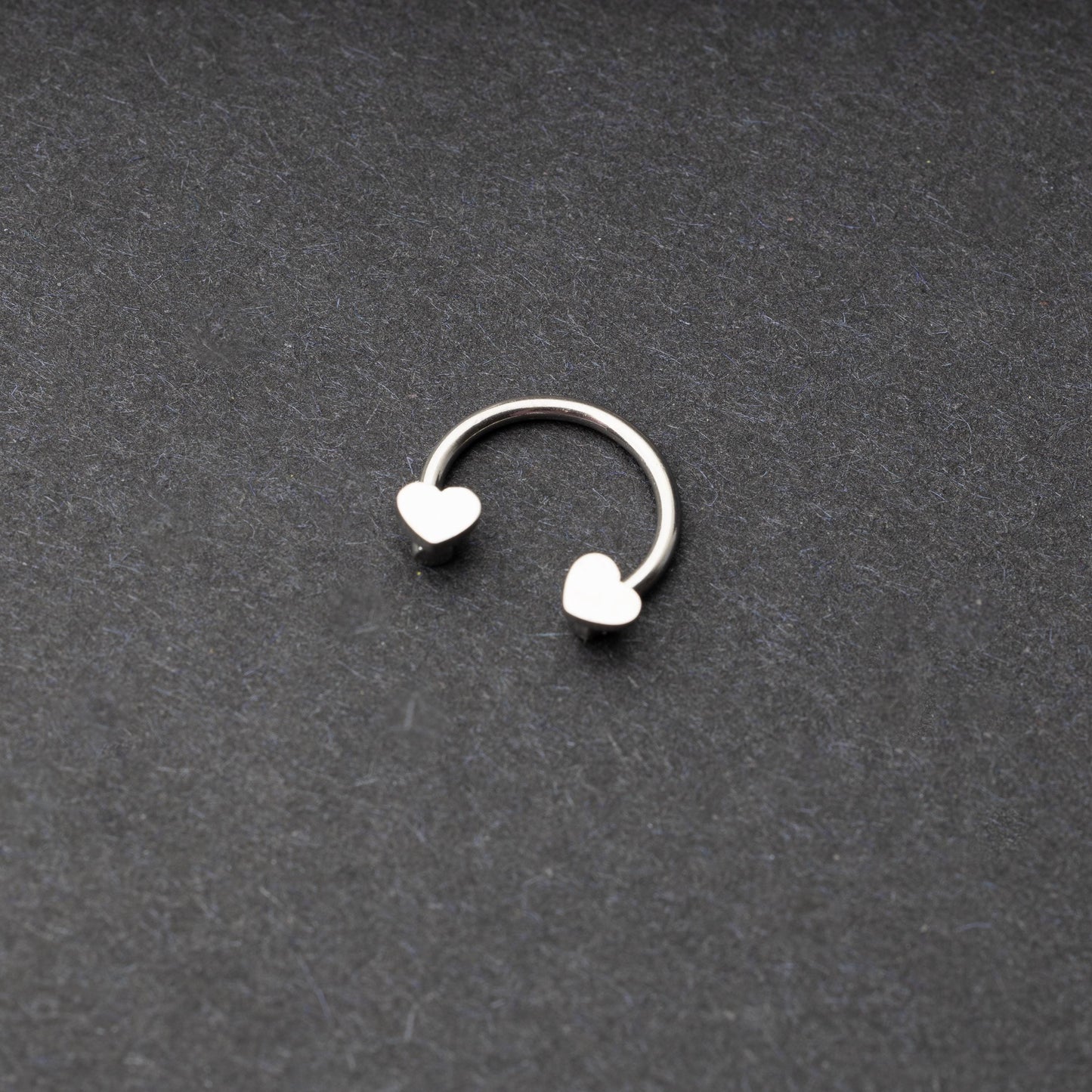 Silver Horsehoe hoop with heart ends in silver. 