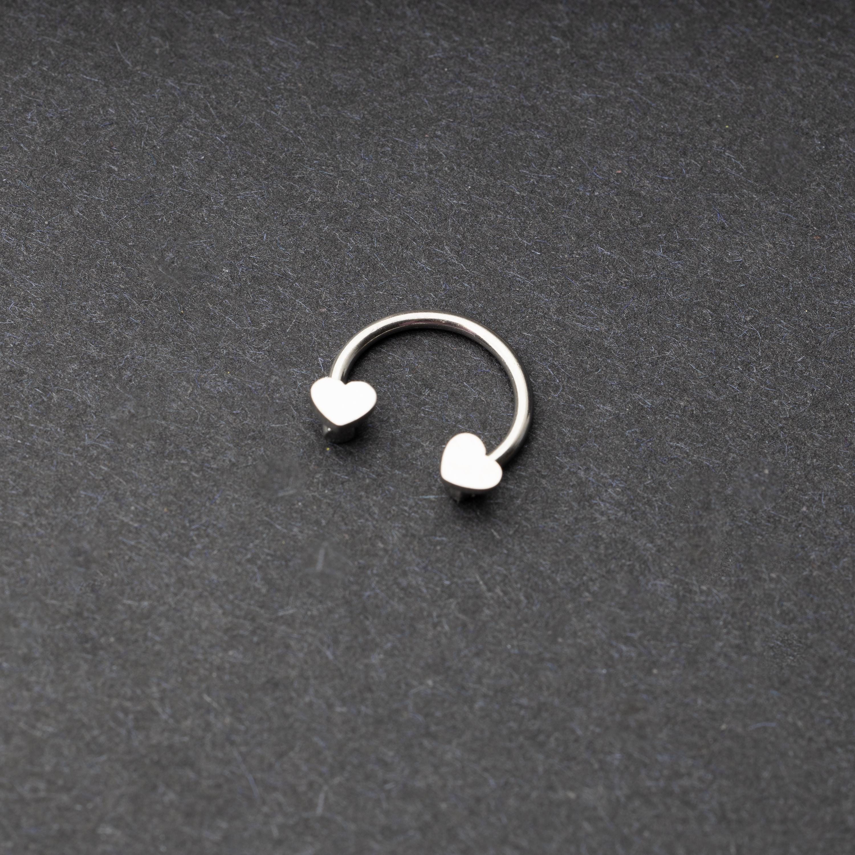 Silver Horsehoe hoop with heart ends in silver. 