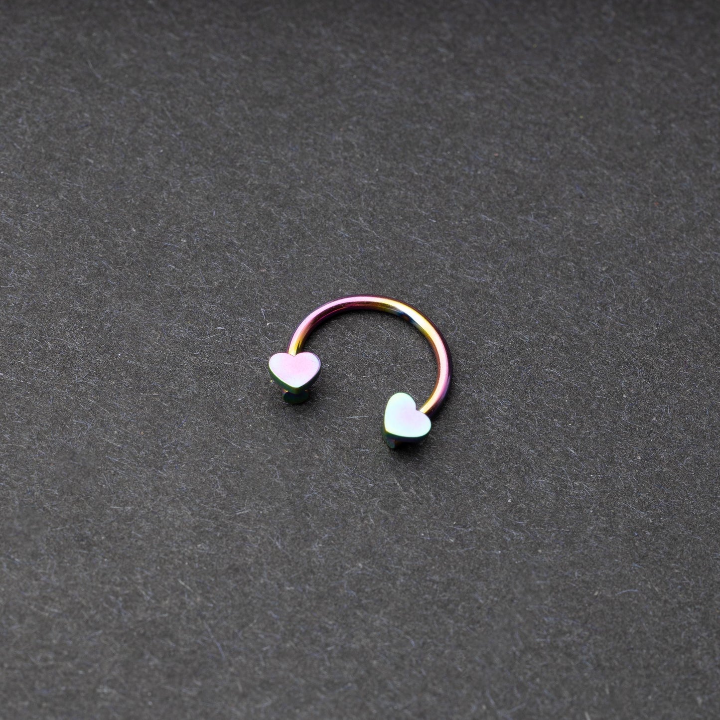 Rainbow Horsehoe hoop with heart ends in silver. 