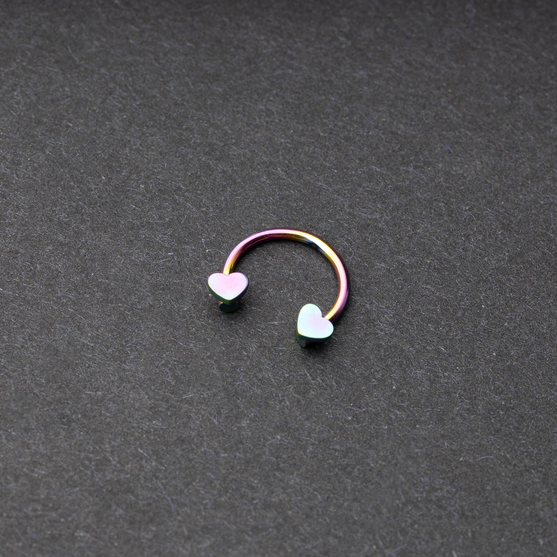 Rainbow Horsehoe hoop with heart ends in silver. 