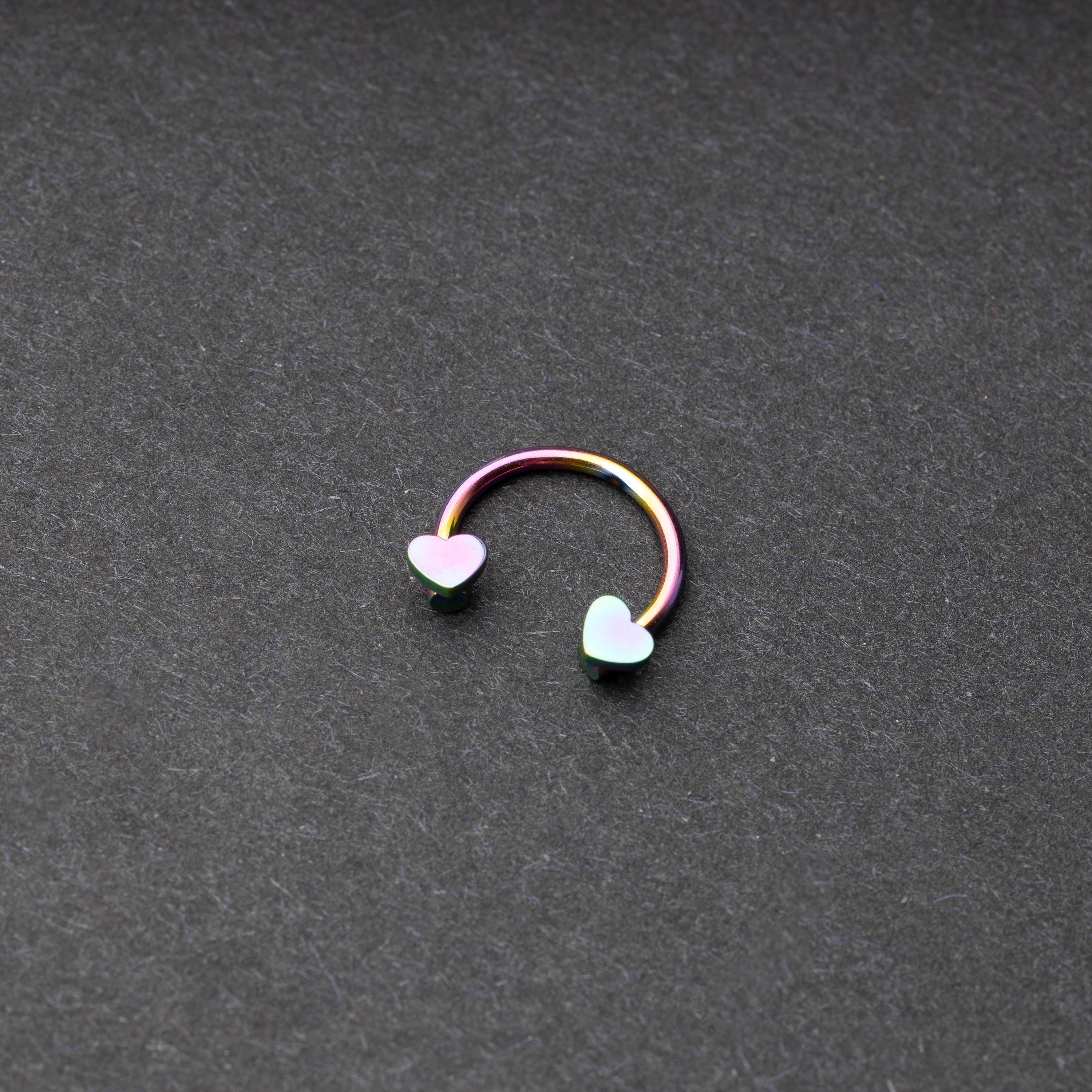 Rainbow Horsehoe hoop with heart ends in silver. 
