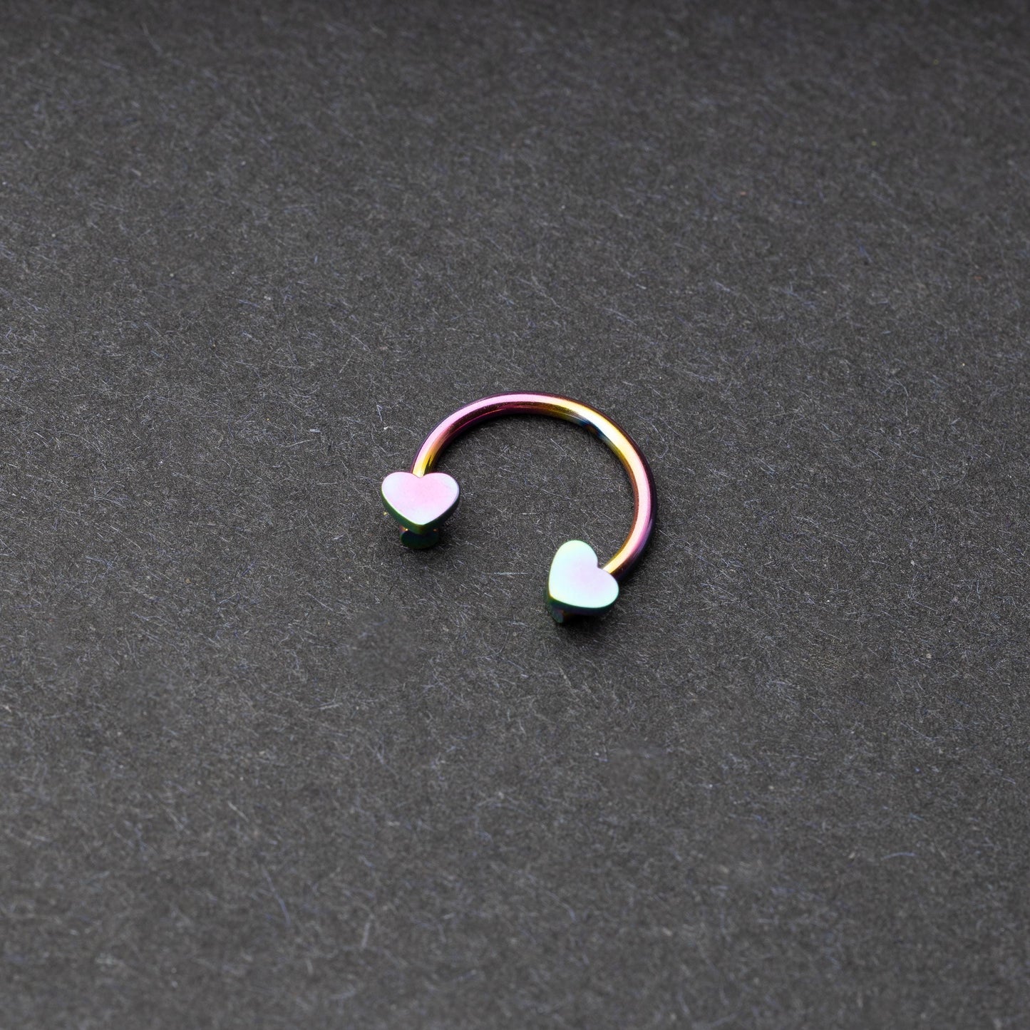 Rainbow Horsehoe hoop with heart ends in silver. 